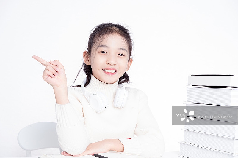 书桌上开心的小学生女孩图片素材