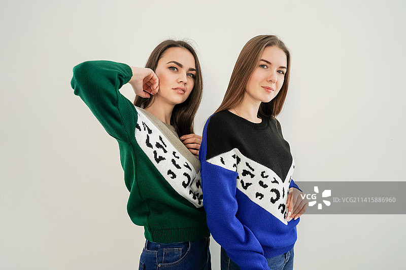 两位穿着毛衣的年轻女性，背景为白色，俄罗斯图片素材