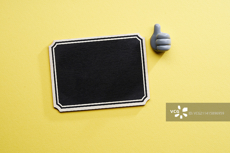 带有竖起大拇指玩具手的迷你黑板，马来西亚图片素材