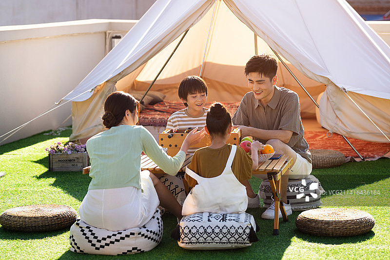 快乐的一家四口在户外玩桌上足球图片素材