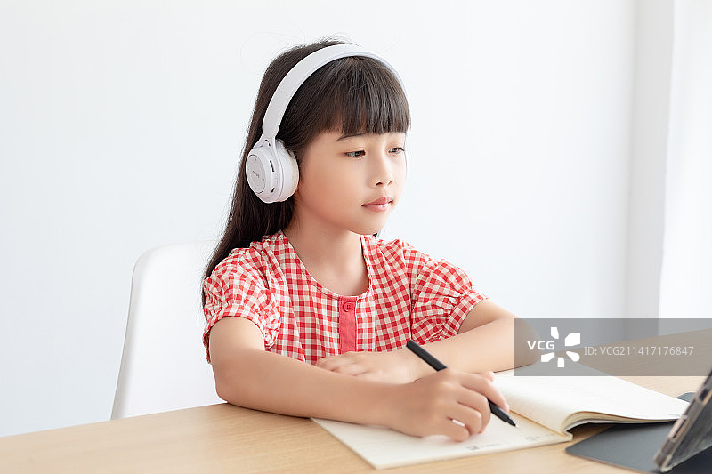 小学生在家使用平板电脑上网课图片素材