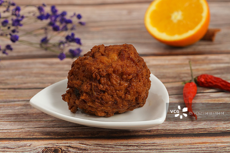 小碟里一个红烧狮子头创意摆拍图片素材