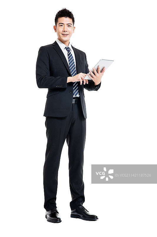 身着深色西装套装手拿平板电脑的年轻男士图片素材