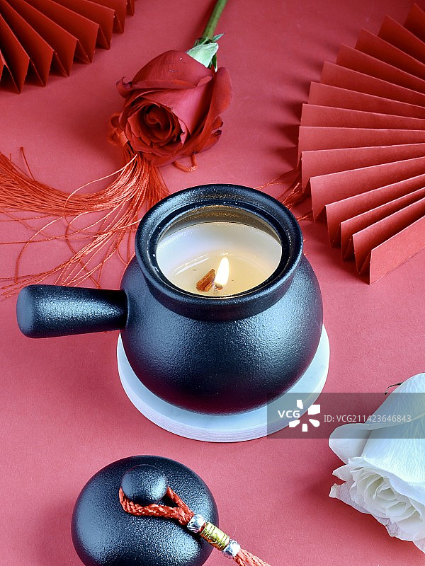情人节快乐——红色背景下的浪漫香薰罐图片素材