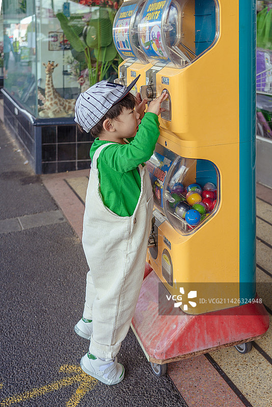 可爱小男孩在玩游艺机图片素材