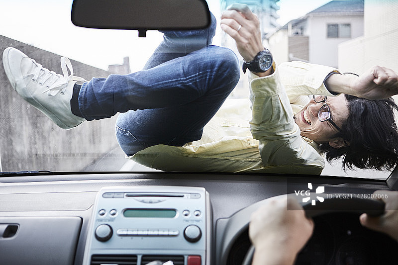 在引擎盖上的男人图片素材