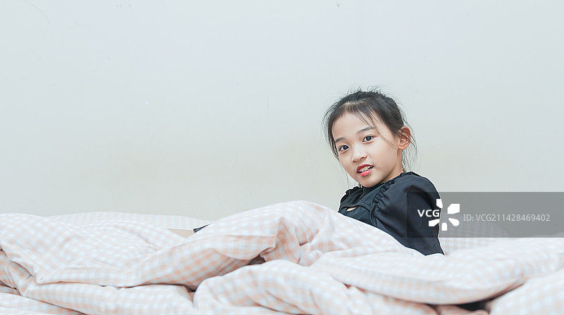 盖着被子的的小女孩图片素材
