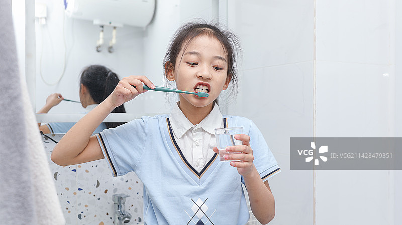 拿着牙刷刷牙的可爱小女孩图片素材