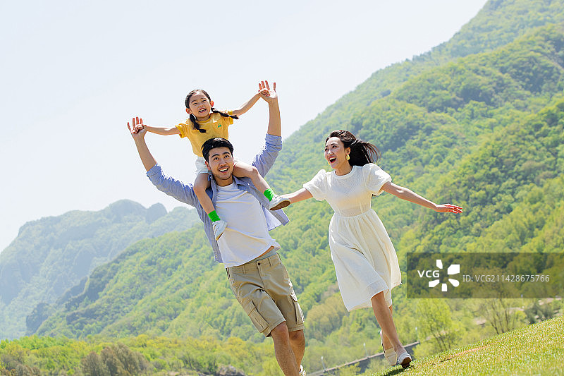 快乐的一家三口在郊区玩耍图片素材