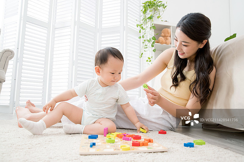 年轻妈妈带着宝宝玩玩具图片素材