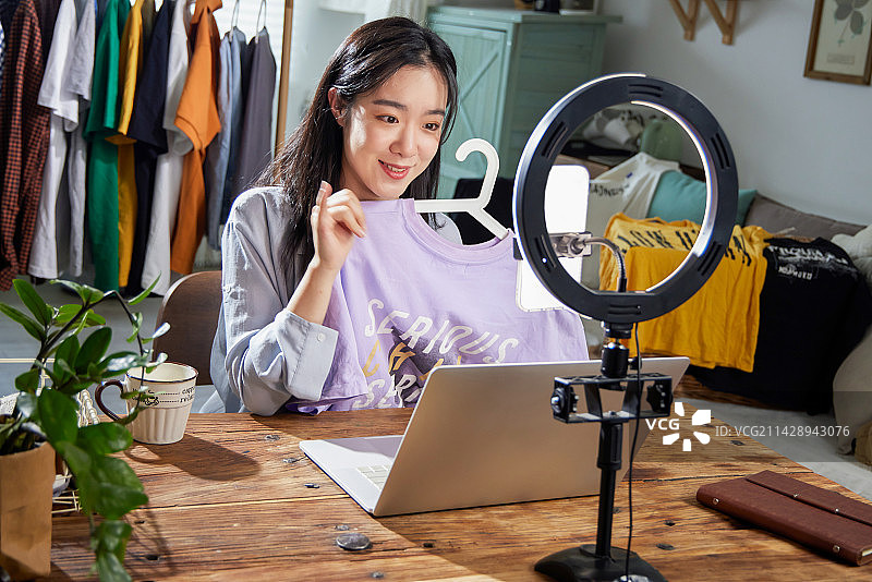 年轻女人在线直播卖衣服图片素材
