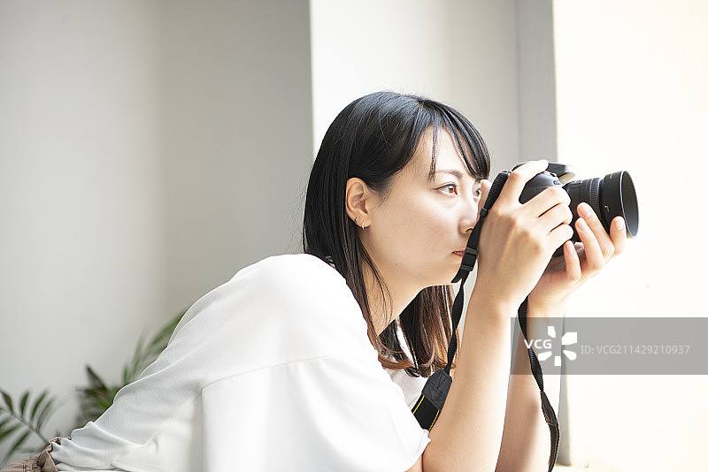 用单反相机拍照的女人图片素材