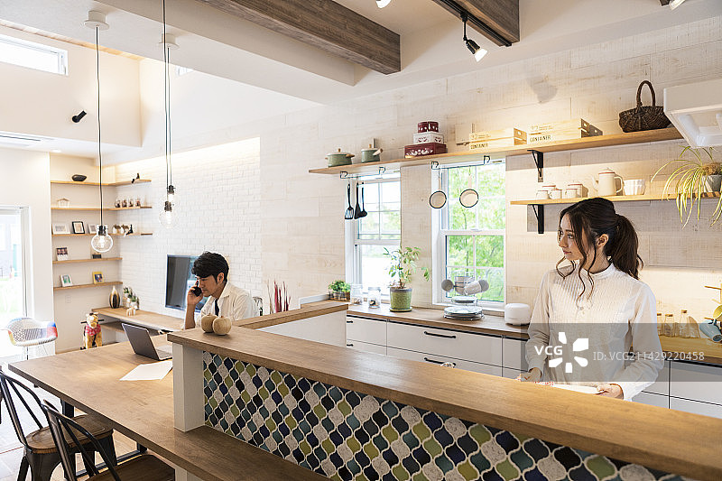 女人做家务，男人在打电话图片素材