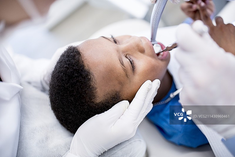 牙医为男孩钻牙图片素材