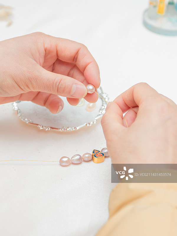 艺术时尚沙龙活动 女性正在制作珍珠首饰 珍珠手链 串珠子图片素材