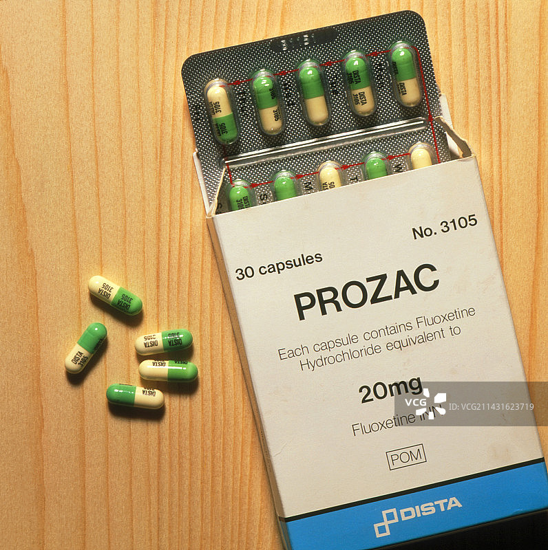 木质表面上的百忧解药盒与药丸图片素材