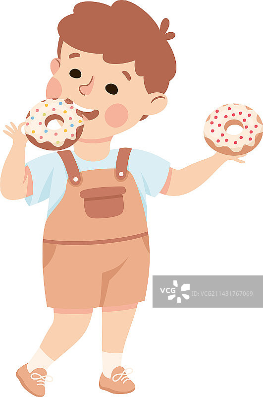 吃着甜甜圈，面带笑容的小男孩图片素材