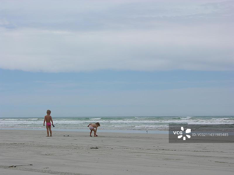 在大洋路上：两个孩子在澳大利亚维多利亚州的沙滩上图片素材