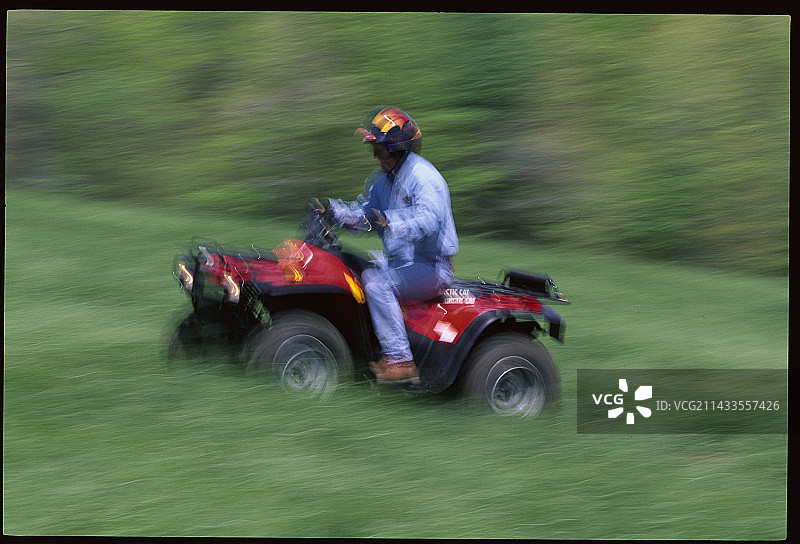 驾驶全地形车穿过草地图片素材