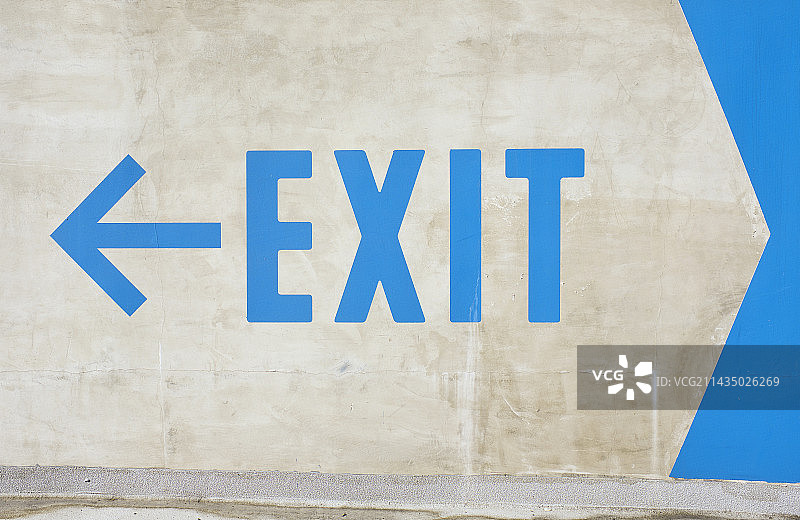 白色墙壁上的蓝色大型出口标志图片素材