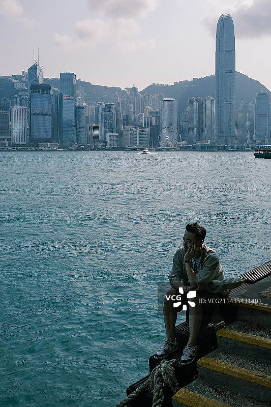 下午坐在香港天星码头岸边的男子图片素材