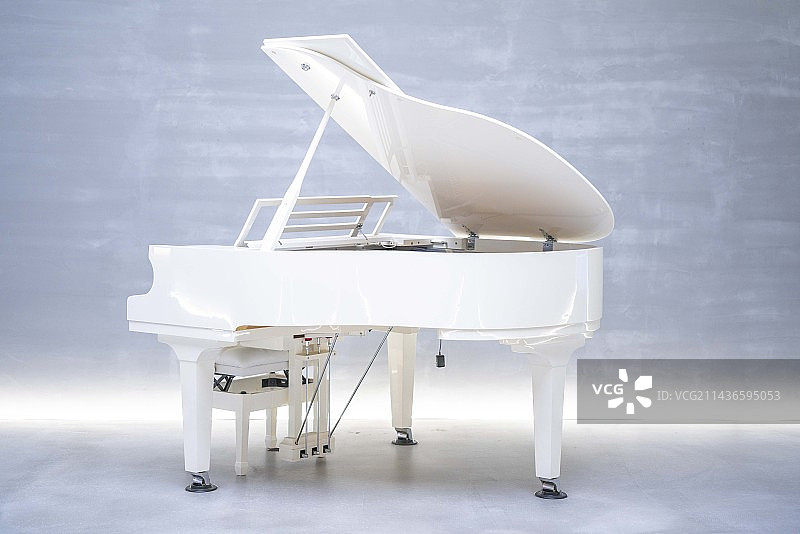 一台白色钢琴陈列在一个干净的室内空间图片素材