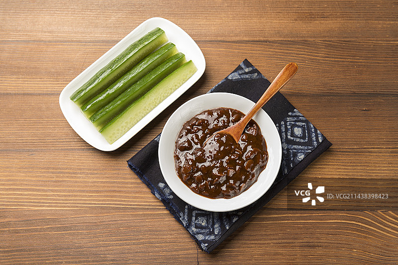 夏季凉菜黄瓜蘸黄豆酱特写木桌面背景图片素材