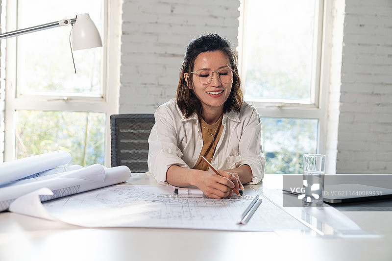 室内画图纸的青年设计师图片素材