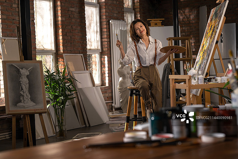 工作室内绘画的青年画家图片素材