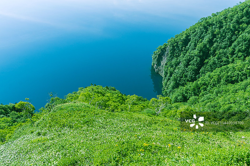 日本北海道弟子屈町湖面和绿色山坡图片素材