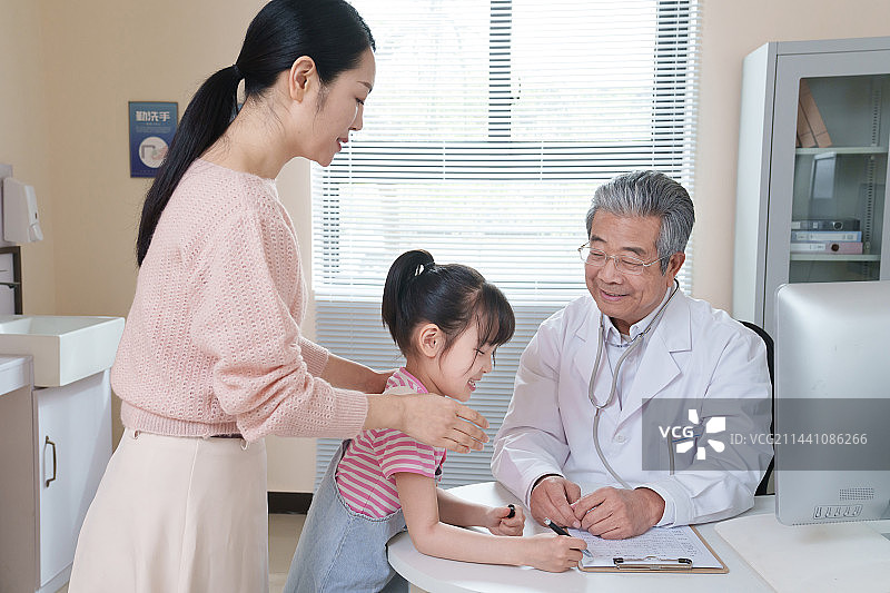 年轻妈妈带着孩子看医生图片素材