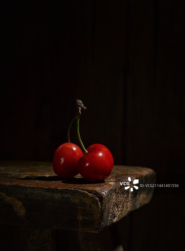 黑色背景下桌子上的樱桃特写镜头图片素材