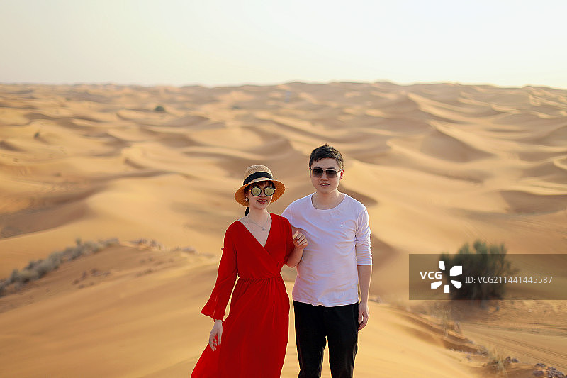 年轻的情侣在沙漠旅行图片素材