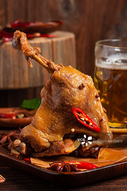 乡村风格美食摄影旧木板上的卤制大鸭腿肉特写图片素材