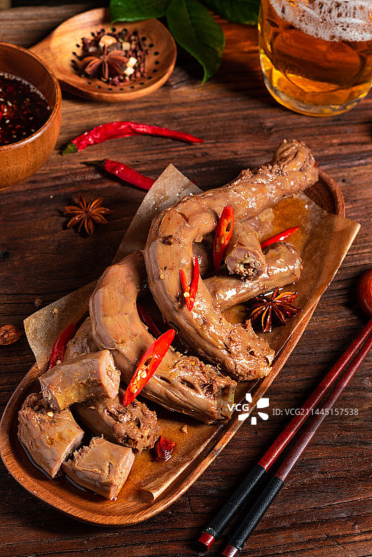 乡村风格美食摄影旧木板上的诱人热卤现捞卤水鸭脖特写图片素材