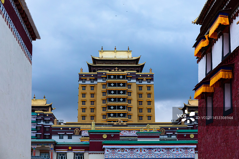 四川阿坝各莫寺辉煌高大的藏传佛教建筑在阴天乌云下的景观图片素材