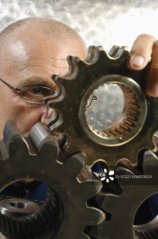 工程师仔细检查金属齿轮图片素材