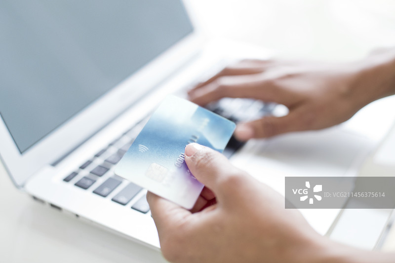 使用信用卡和笔记本电脑的女人图片素材