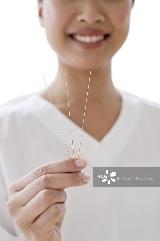 女人手持针灸针图片素材