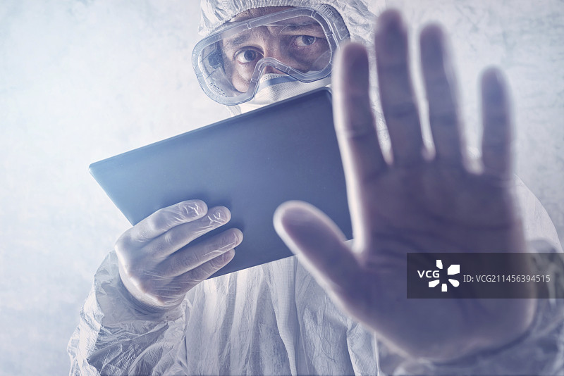 身穿防护服并手持平板电脑的科学家图片素材