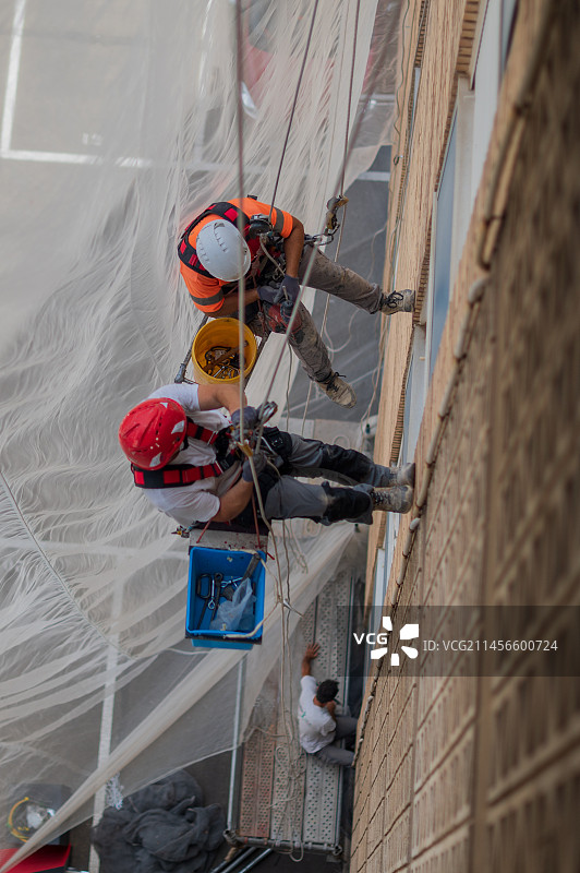 住宅楼上的高空作业工人图片素材