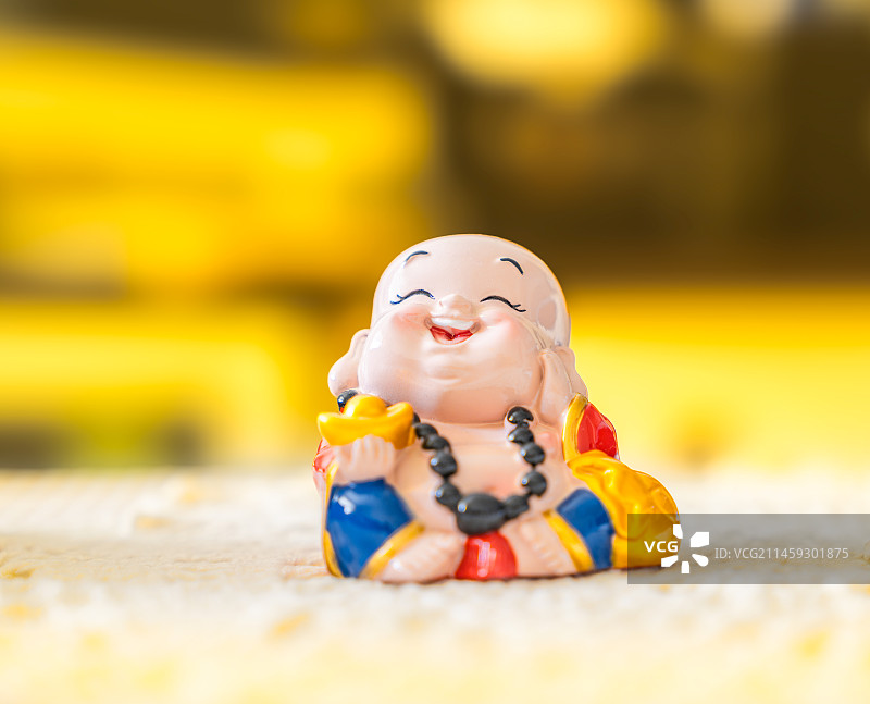 黄金屋中的手拿金元宝的财神弥勒佛装饰品图片素材