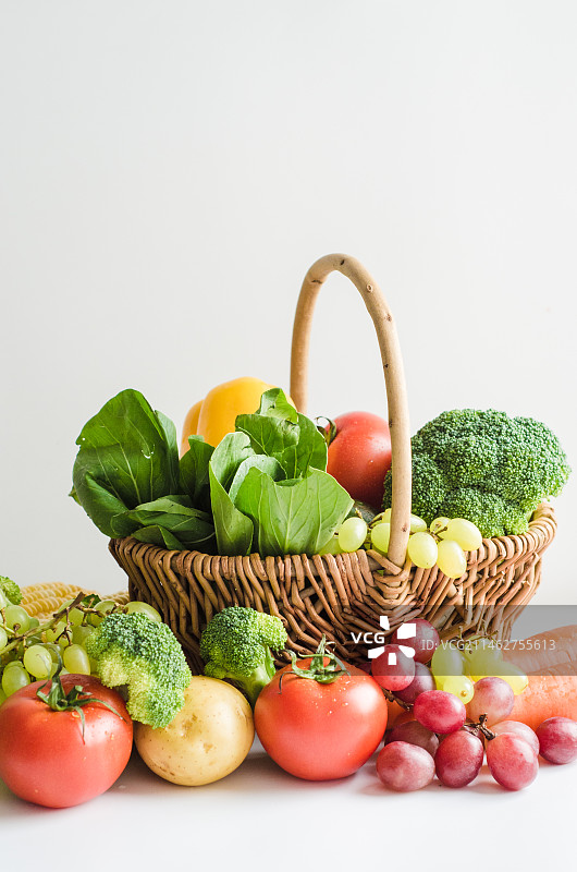 木桌子上菜篮子里的新鲜水果蔬菜图片素材