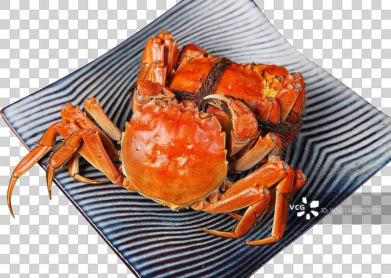 蒸好的螃蟹放在盘子里图片素材