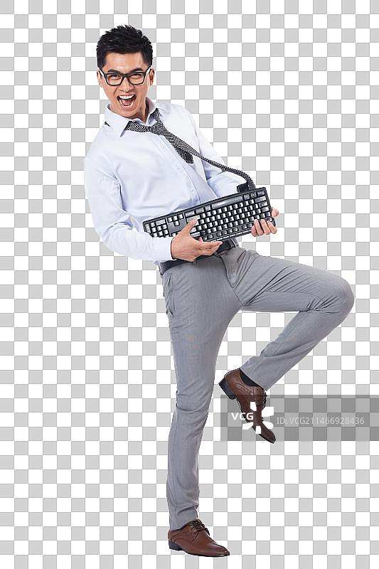 商务男士拿着键盘跳舞图片素材