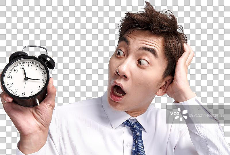 震惊的商务青年男人拿着闹钟图片素材