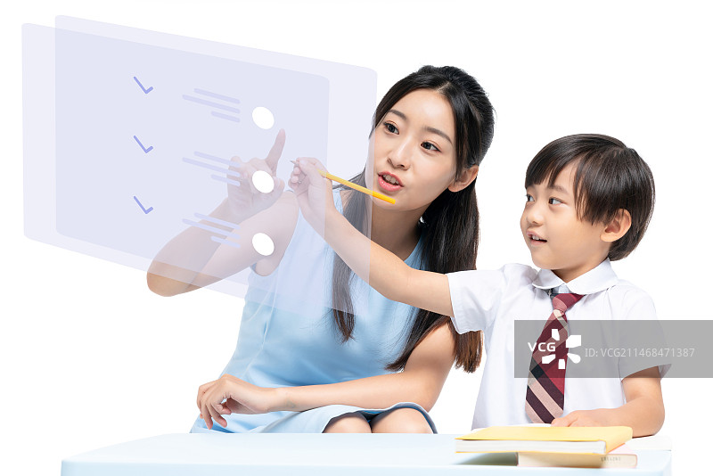 年轻女老师辅导小男孩学习图片素材