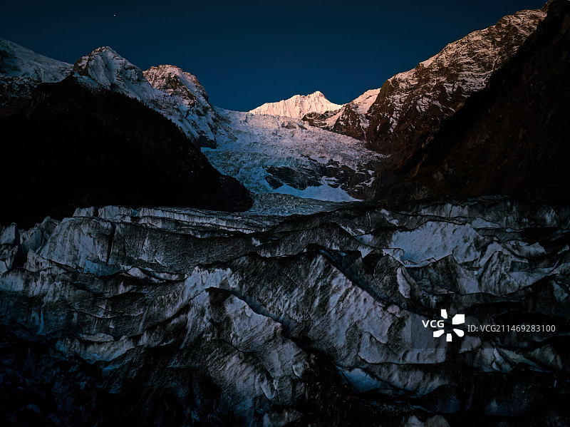 在寒冷的冬季早晨等待梅里雪山明永冰川的日出图片素材