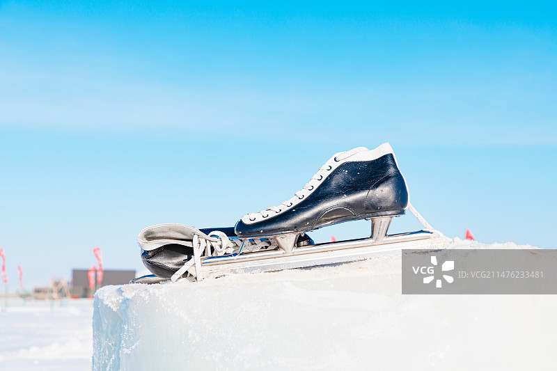 一双黑色的冰鞋放在冰雪堆上图片素材