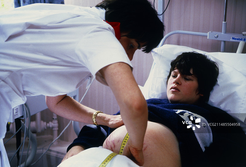 助产士评估处于早期分娩的孕妇图片素材